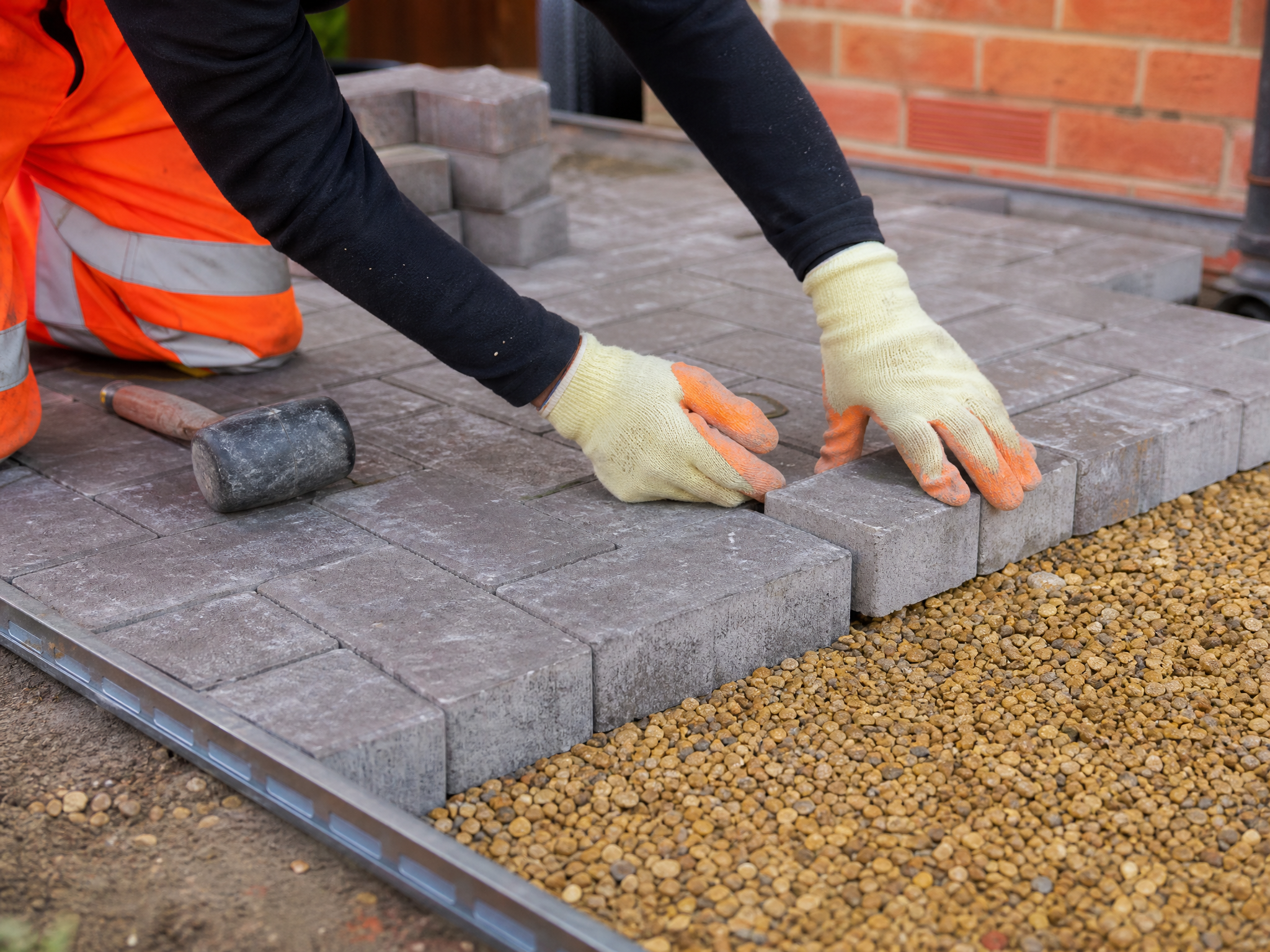 Professional installer carrying out permeable driveways in a British residential property