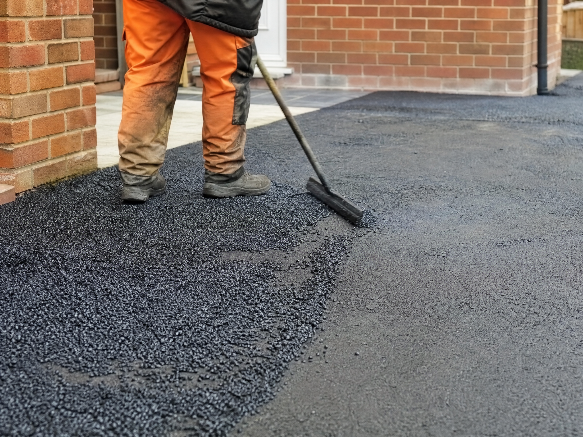 Close-up detail relevant to resin over tarmac & concrete — showing materials and installation technique